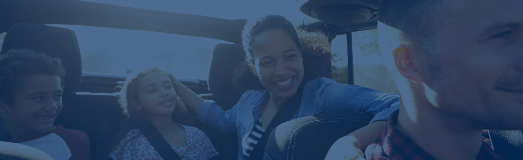 Happy family riding in a car