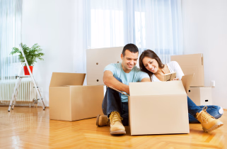 Couple unpacking boxes in their new apartment