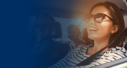 Happy family driving in a car on a sunny day