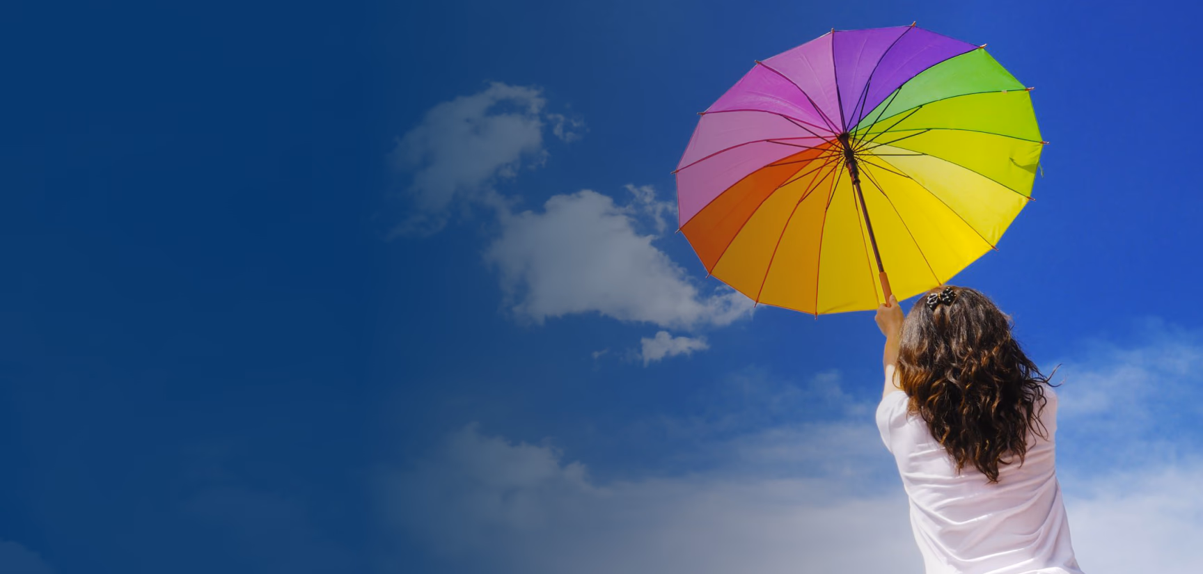 Girl holding a rainbow umbrella