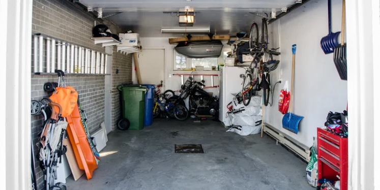 inside of a single car garage with household items along sides