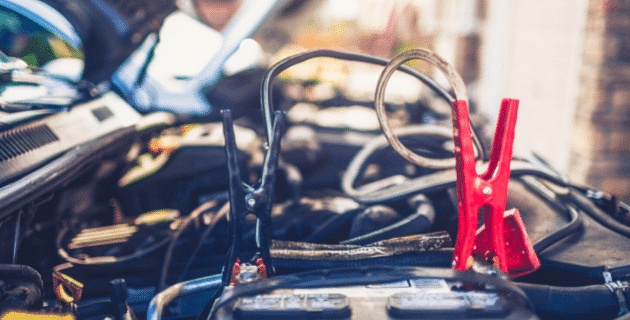 jumper cables attached to car battery