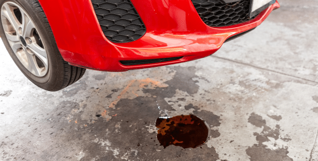parked car with puddle under it