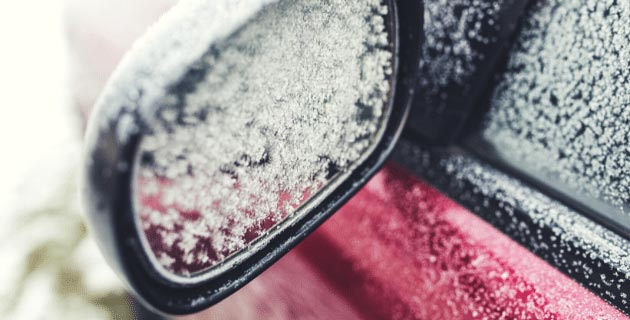 vehicle side mirror covered in ice crystals